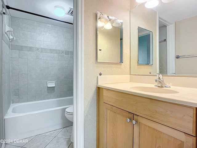 full bathroom with vanity, tile patterned floors, toilet, and tiled shower / bath