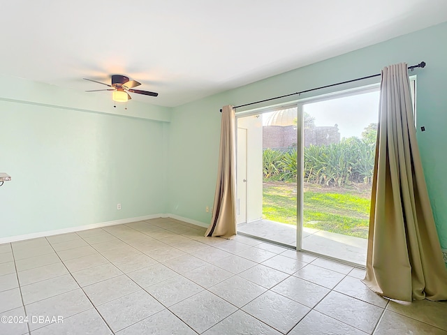 spare room featuring ceiling fan and light tile patterned floors