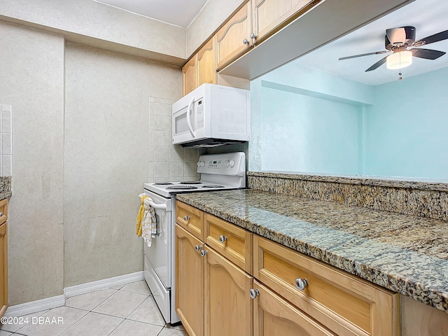 kitchen with dark stone counters, light tile patterned floors, ceiling fan, backsplash, and white appliances