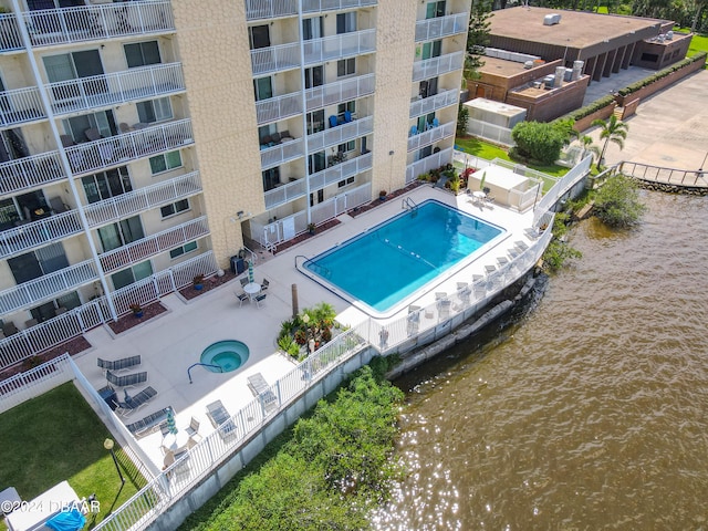 view of pool featuring a patio and a water view