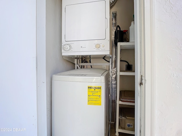 clothes washing area featuring stacked washer / drying machine