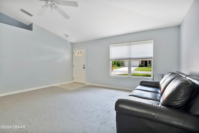 living room featuring lofted ceiling, light colored carpet, and ceiling fan