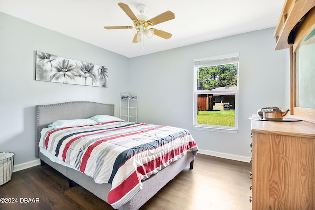 bedroom with dark hardwood / wood-style flooring and ceiling fan