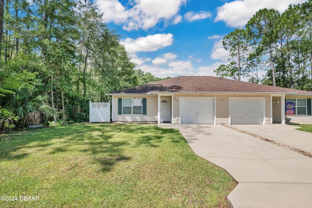 ranch-style house featuring a garage and a front lawn