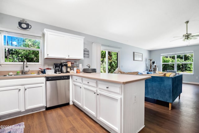 kitchen featuring dishwasher, dark wood-type flooring, kitchen peninsula, and sink