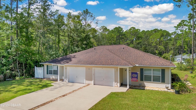 single story home with a garage and a front lawn