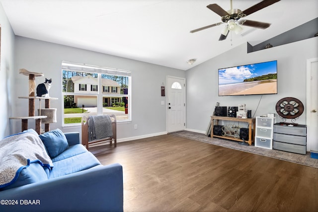 living room with dark hardwood / wood-style flooring, ceiling fan, and vaulted ceiling