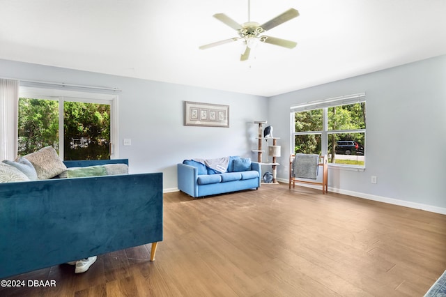 living room with light wood-type flooring and ceiling fan