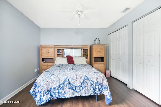 bedroom with multiple closets, ceiling fan, and dark hardwood / wood-style floors