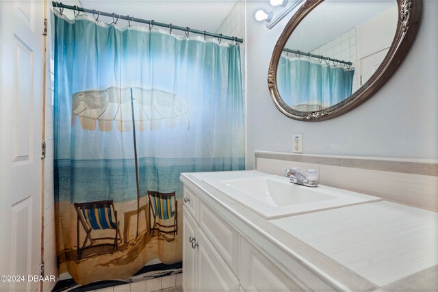 bathroom featuring vanity and curtained shower