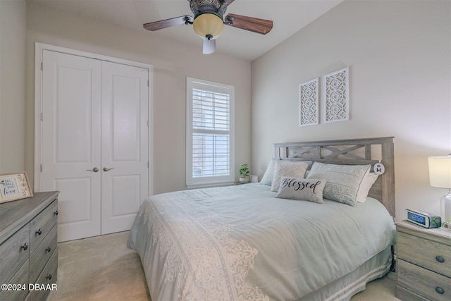 carpeted bedroom featuring ceiling fan and a closet