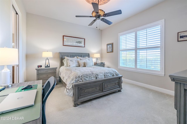 bedroom featuring light colored carpet and ceiling fan