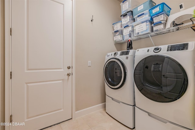 washroom with separate washer and dryer and light tile patterned floors