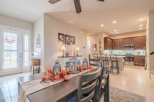 dining area with light tile patterned floors and ceiling fan