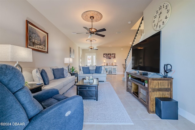 living room with ceiling fan and light tile patterned flooring