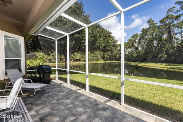 unfurnished sunroom with a water view