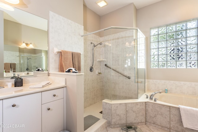 bathroom featuring independent shower and bath, vanity, and tile patterned floors