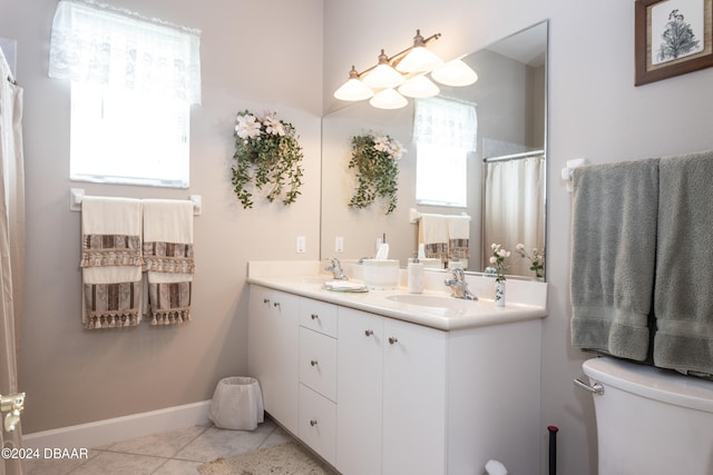 bathroom featuring vanity, tile patterned flooring, and toilet