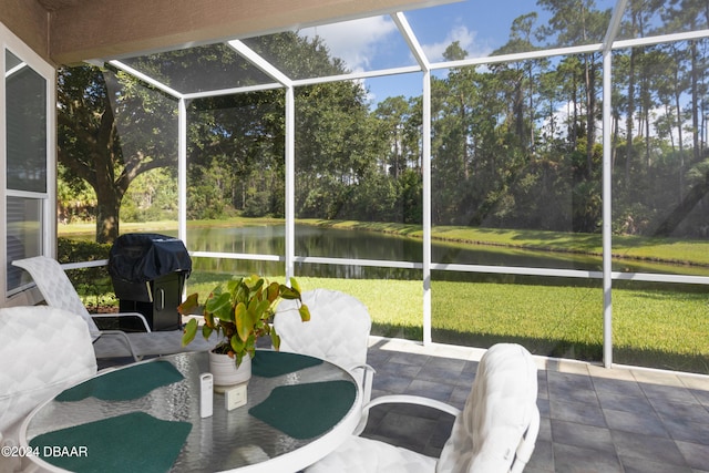 unfurnished sunroom featuring a water view