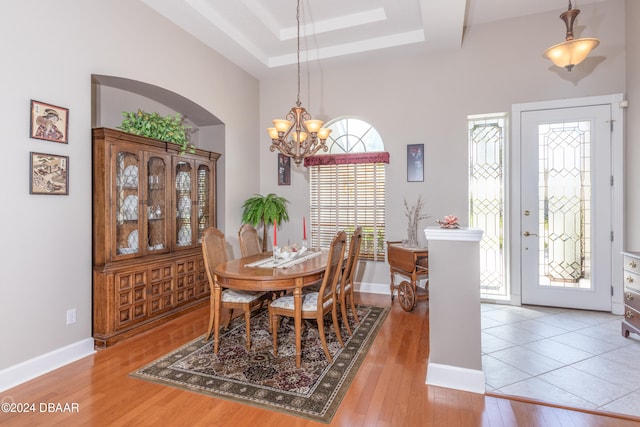 dining area featuring an inviting chandelier and light hardwood / wood-style flooring