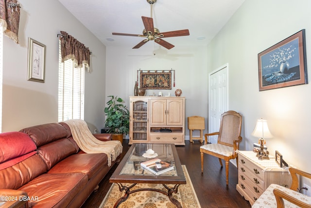 living room featuring ceiling fan and dark hardwood / wood-style floors