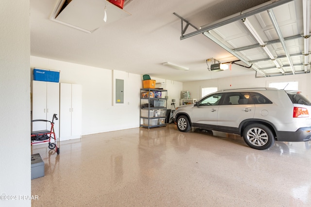 garage featuring electric panel and a garage door opener