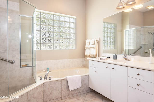 bathroom with vanity, a wealth of natural light, tile patterned floors, and shower with separate bathtub