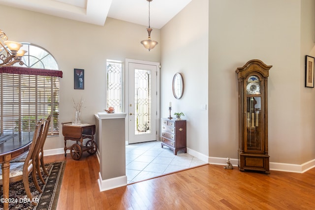 entrance foyer featuring light hardwood / wood-style floors and a towering ceiling