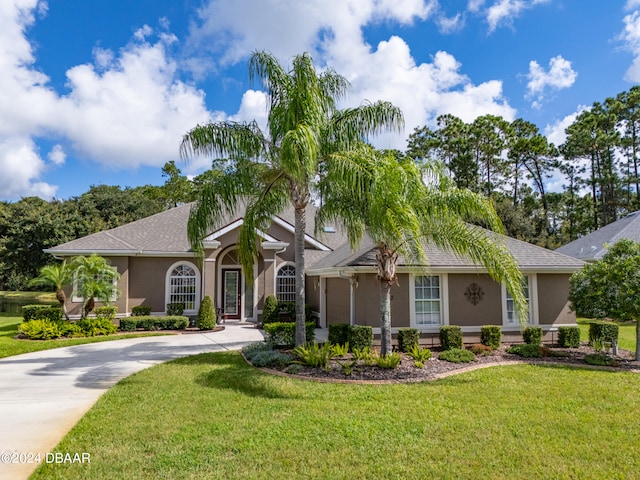 ranch-style home featuring a front yard