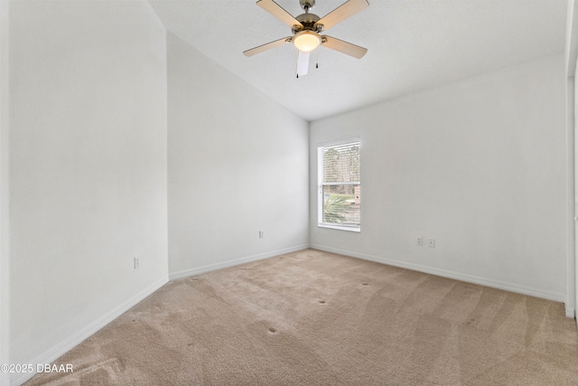 carpeted empty room featuring lofted ceiling and ceiling fan