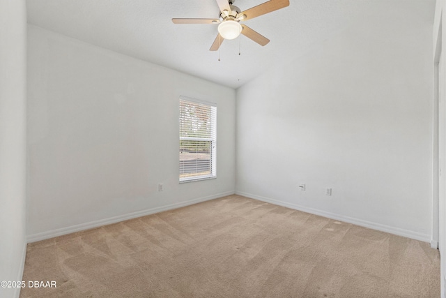 carpeted spare room with lofted ceiling and ceiling fan