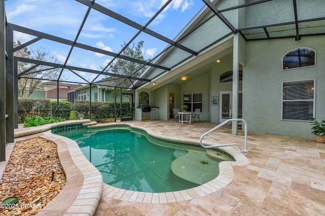 view of pool featuring a lanai, exterior kitchen, and a patio area