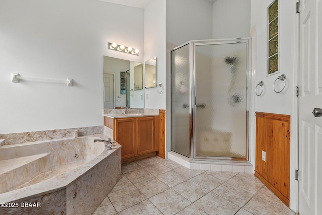 bathroom featuring independent shower and bath, vanity, and tile patterned floors