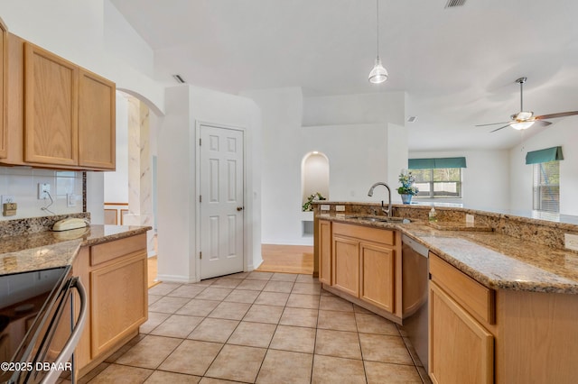 kitchen featuring stainless steel appliances, sink, and light brown cabinetry