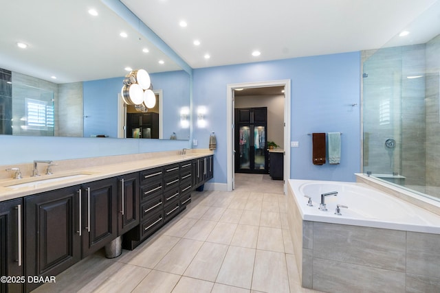 650 Woodbridge Dr, Ormond Beach, FL 32174 - full bath with double vanity, a bath, tile patterned flooring, a shower stall, and recessed lighting