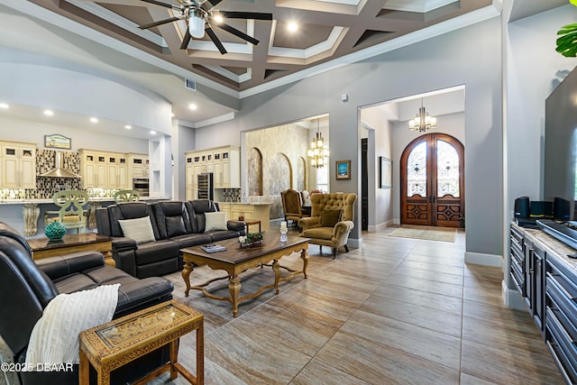 650 Woodbridge Dr, Ormond Beach, FL 32174 - living room with a chandelier, ornamental molding, coffered ceiling, a towering ceiling, and a ceiling fan
