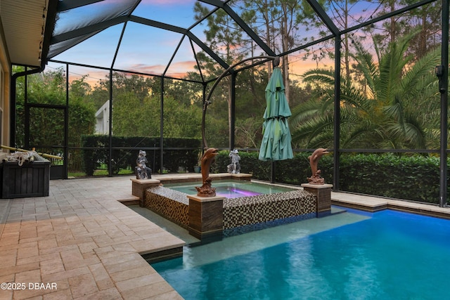 650 Woodbridge Dr, Ormond Beach, FL 32174 - pool at dusk featuring an in-ground hot tub, a patio area, glass enclosure, and an outdoor pool