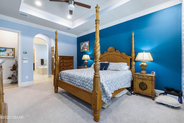 650 Woodbridge Dr, Ormond Beach, FL 32174 - bedroom with arched walkways, carpet, crown molding, baseboards, and a raised ceiling