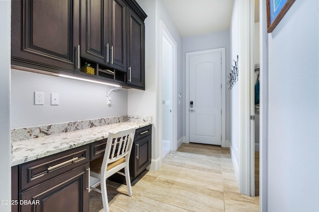 650 Woodbridge Dr, Ormond Beach, FL 32174 - bar area featuring built in study area and baseboards