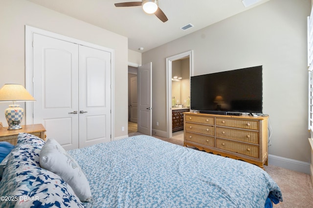 650 Woodbridge Dr, Ormond Beach, FL 32174 - carpeted bedroom with baseboards, a closet, a ceiling fan, and ensuite bath
