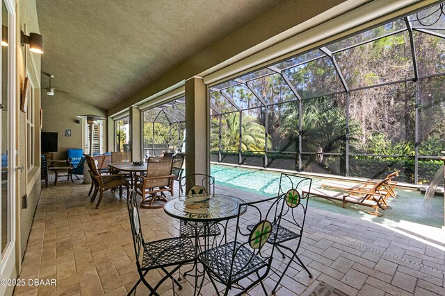650 Woodbridge Dr, Ormond Beach, FL 32174 - sunroom featuring vaulted ceiling, a swimming pool, and a ceiling fan