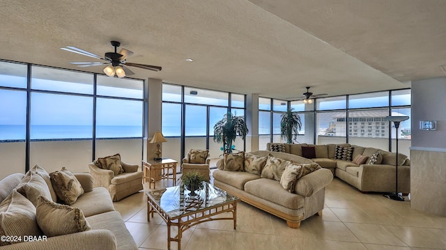 2615 S Atlantic Ave Unit 5C, Daytona Beach Shores, FL 32118 - living area featuring ceiling fan, a textured ceiling, light tile patterned flooring, and floor to ceiling windows