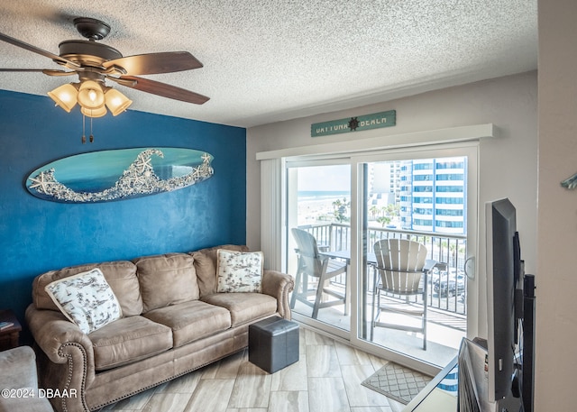 living room featuring a textured ceiling and ceiling fan