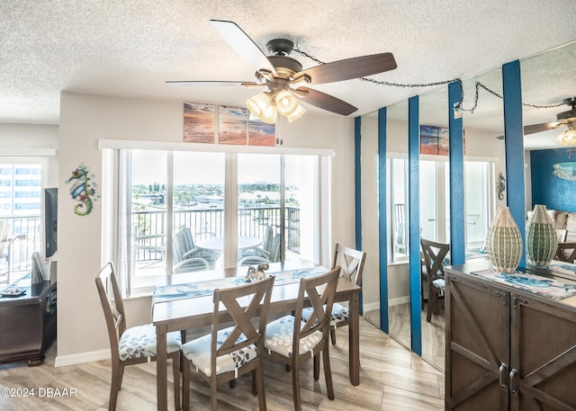 2615 S Atlantic Ave Unit 5C, Daytona Beach Shores, FL 32118 - dining room with a textured ceiling, a ceiling fan, baseboards, and light wood-type flooring