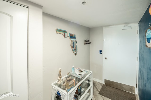 interior space featuring washing machine and dryer and light hardwood / wood-style flooring