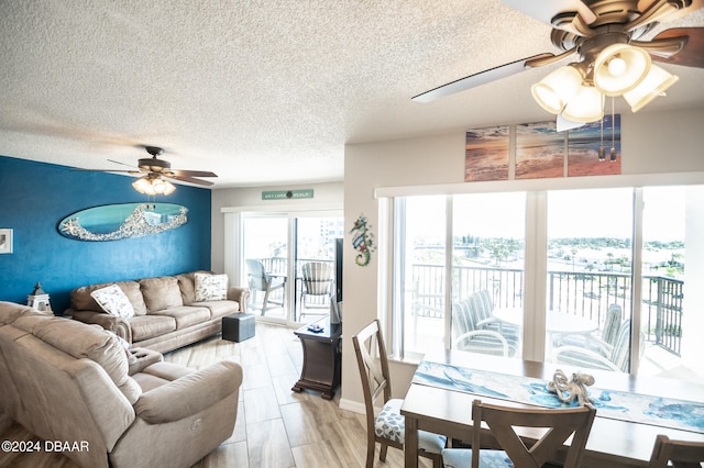 living room with a textured ceiling and ceiling fan