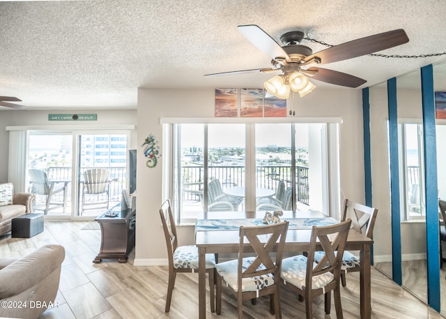 dining area with ceiling fan and a textured ceiling