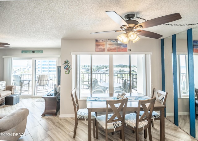 2615 S Atlantic Ave Unit 5C, Daytona Beach Shores, FL 32118 - dining room featuring ceiling fan, a textured ceiling, and baseboards