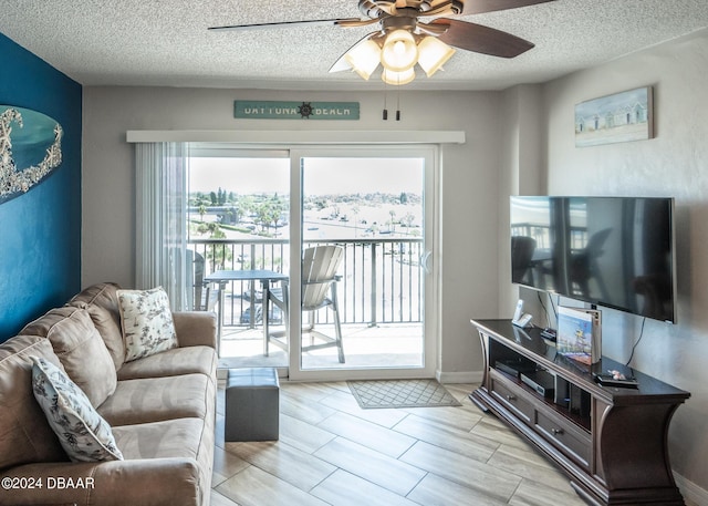 2615 S Atlantic Ave Unit 5C, Daytona Beach Shores, FL 32118 - living area featuring a ceiling fan and a textured ceiling