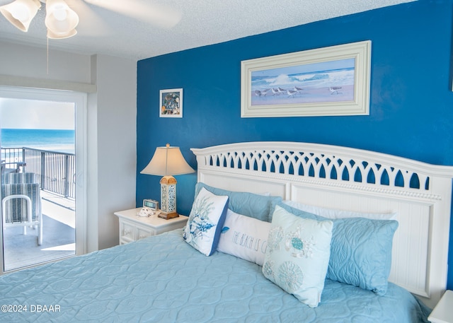 bedroom with a textured ceiling and ceiling fan